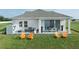 Spacious backyard with patio, dining area, seating and manicured lawn at 11313 Hardwood Hammock Ln, Riverview, FL 33569