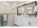 Modern bathroom featuring double sinks, quartz countertops, and stylish lighting at 11313 Hardwood Hammock Ln, Riverview, FL 33569