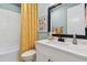 Bathroom featuring a white vanity, black faucet, and patterned yellow shower curtain at 11313 Hardwood Hammock Ln, Riverview, FL 33569