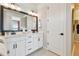 Bathroom featuring double sinks with modern fixtures, stylish mirrors, and plenty of counter space at 11313 Hardwood Hammock Ln, Riverview, FL 33569