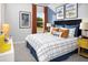 Bright bedroom with blue walls, plaid bedding, and fun, playful artwork at 11313 Hardwood Hammock Ln, Riverview, FL 33569