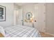 Neutral bedroom with plaid bedspread and white dresser at 11313 Hardwood Hammock Ln, Riverview, FL 33569