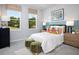 Cozy bedroom with colorful accents, two windows and natural light at 11313 Hardwood Hammock Ln, Riverview, FL 33569