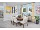 Contemporary dining room featuring a wooden table, six chairs, and stylish decor at 11313 Hardwood Hammock Ln, Riverview, FL 33569