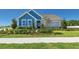Charming single Gathering home with well manicured landscaping and lovely blue accents at 11313 Hardwood Hammock Ln, Riverview, FL 33569