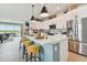 Spacious kitchen with a large island, white cabinets, stainless steel appliances, and view of waterfront at 11313 Hardwood Hammock Ln, Riverview, FL 33569