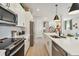 Modern kitchen features stainless appliances, an island with bar seating, sleek countertops, and plenty of storage space at 11313 Hardwood Hammock Ln, Riverview, FL 33569
