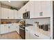 A contemporary kitchen has stainless appliances, modern cabinetry, tile backsplash, and sleek countertops at 11313 Hardwood Hammock Ln, Riverview, FL 33569