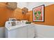 Well-organized laundry room with white washer and dryer at 11313 Hardwood Hammock Ln, Riverview, FL 33569