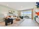 Inviting living room with comfortable seating, stylish decor, and expansive sliding glass doors leading to the outdoor patio with water view at 11313 Hardwood Hammock Ln, Riverview, FL 33569