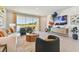 Bright living room with a large sliding glass door offering beautiful views of the water and outdoor area, plush seating, and decor at 11313 Hardwood Hammock Ln, Riverview, FL 33569