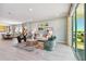Bright living room with modern decor, stylish furniture, and large windows, enhancing natural light at 11313 Hardwood Hammock Ln, Riverview, FL 33569