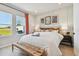 Serene main bedroom featuring paneled wall, natural light, and views of the outdoor landscape at 11313 Hardwood Hammock Ln, Riverview, FL 33569