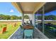 Covered patio features a wood dining table, blue chairs, and access to the backyard at 11313 Hardwood Hammock Ln, Riverview, FL 33569