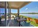 Covered patio with outdoor dining table, lake view, and chairs at 11313 Hardwood Hammock Ln, Riverview, FL 33569