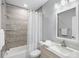 Well-lit bathroom with modern vanity, granite countertop, and a tiled shower with glass door at 11510 Shipwatch Dr # 1372, Largo, FL 33774