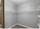 Spacious walk-in closet with wire shelving and wood-look flooring is perfect for organizing clothes and accessories at 11510 Shipwatch Dr # 1372, Largo, FL 33774