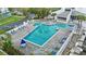 Inviting community pool featuring a unique shape with plenty of lounge chairs and shaded seating areas for residents at 11510 Shipwatch Dr # 1372, Largo, FL 33774