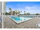 Community pool surrounded by chairs for sunbathing in a landscaped community with lush tropical foliage at 11510 Shipwatch Dr # 1372, Largo, FL 33774