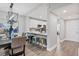 Open dining area with modern light fixture, breakfast bar and view of kitchen at 11510 Shipwatch Dr # 1372, Largo, FL 33774