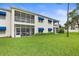 The back exterior view of this condo showcases large windows and a beautiful yard at 11510 Shipwatch Dr # 1372, Largo, FL 33774