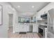 Modern kitchen featuring stainless steel appliances and sleek white cabinetry at 11510 Shipwatch Dr # 1372, Largo, FL 33774