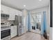 Well-lit kitchen with stainless steel appliances and large windows at 11510 Shipwatch Dr # 1372, Largo, FL 33774