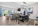 Open-concept living area with dining table, comfortable seating and lots of light at 11510 Shipwatch Dr # 1372, Largo, FL 33774