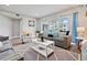 Bright living room featuring comfortable seating, neutral decor and natural light at 11510 Shipwatch Dr # 1372, Largo, FL 33774
