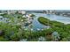 Aerial view shows community marina with many boats docked, nestled along the water and green landscape at 11510 Shipwatch Dr # 1372, Largo, FL 33774