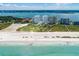 Beautiful aerial shot of coastal condos, a sandy beach, and the clear ocean water at 1170 Gulf Blvd # 1006, Clearwater Beach, FL 33767