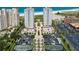 Aerial view showcases the condo towers, beach, tennis courts, and neatly arranged parking at 1170 Gulf Blvd # 1006, Clearwater Beach, FL 33767