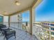 Serene balcony featuring cozy seating and breathtaking views of the beach, pool, and cityscape at 1170 Gulf Blvd # 1006, Clearwater Beach, FL 33767