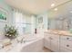 Bright bathroom featuring a tub, window and vanity at 1170 Gulf Blvd # 1006, Clearwater Beach, FL 33767