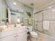 Bright bathroom featuring a vanity, toilet, and shower with glass door at 1170 Gulf Blvd # 1006, Clearwater Beach, FL 33767