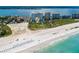 Sweeping beachside view featuring white sand, blue umbrellas, and the building's impressive waterfront location at 1170 Gulf Blvd # 1006, Clearwater Beach, FL 33767