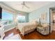 Bright bedroom featuring a bed, chair, ceiling fan and windows at 1170 Gulf Blvd # 1006, Clearwater Beach, FL 33767