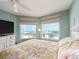 Bright bedroom featuring a bed, two windows, and a television at 1170 Gulf Blvd # 1006, Clearwater Beach, FL 33767