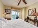 Well-lit bedroom with desk space and balcony access offering scenic views at 1170 Gulf Blvd # 1006, Clearwater Beach, FL 33767