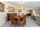 Elegant dining room featuring a wooden table, decorative mirror, and chandelier lighting at 1170 Gulf Blvd # 1006, Clearwater Beach, FL 33767