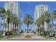 Luxury towers provide an exquisite backdrop amidst lush palm trees and a welcoming brick entrance at 1170 Gulf Blvd # 1006, Clearwater Beach, FL 33767