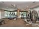 Well-equipped gym with treadmills, stationary bikes, and weight machines overlooking a balcony at 1170 Gulf Blvd # 1006, Clearwater Beach, FL 33767