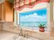 Kitchen sink with a window view of the ocean and nearby city at 1170 Gulf Blvd # 1006, Clearwater Beach, FL 33767