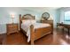 Comfortable main bedroom featuring warm wood floors, complementary furniture, and ample natural light at 1170 Gulf Blvd # 1006, Clearwater Beach, FL 33767