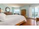 Relaxing main bedroom with light blue walls, warm wood floors and access to a private balcony at 1170 Gulf Blvd # 1006, Clearwater Beach, FL 33767