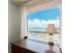 Bright office space with lots of light offering bay view and a desk with a lamp at 1170 Gulf Blvd # 1006, Clearwater Beach, FL 33767