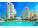 Beautiful swimming pool with towering condominium buildings and verdant landscaping at 1170 Gulf Blvd # 1006, Clearwater Beach, FL 33767