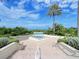 Beautiful view of the pool area with a small fountain and lush tropical surroundings at 1170 Gulf Blvd # 1006, Clearwater Beach, FL 33767