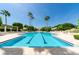 Inviting community pool with palm trees and plenty of lounge seating for relaxation at 1170 Gulf Blvd # 1006, Clearwater Beach, FL 33767