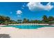 Large community swimming pool with lounge chairs and lush tropical landscaping at 1170 Gulf Blvd # 1006, Clearwater Beach, FL 33767